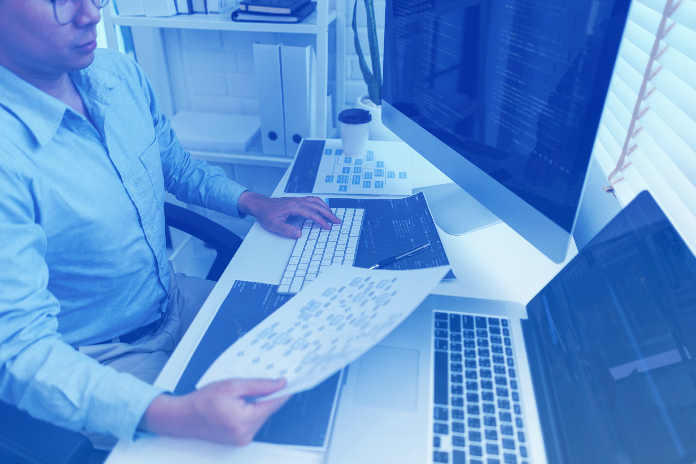 Software development concept, Male programmer read data on docum
